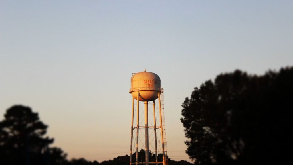Town water tower against a sunset sky